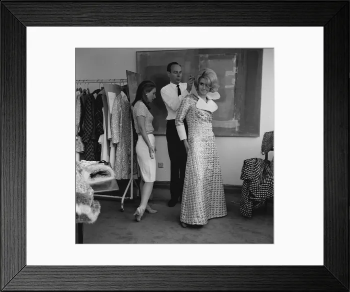 Framed Print : Graziella Fontana fashion June 1965 Model being helped into a long checked coat Framed Print : Graziella Fontana fashion June 1965 Model being helped into a long checked coat