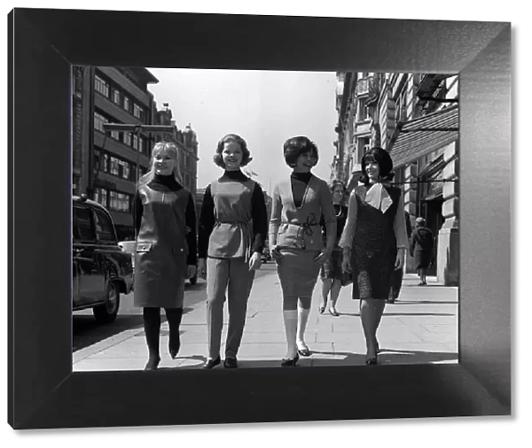Teenage Fashion in the sixties Four young women walk downt the street - two are