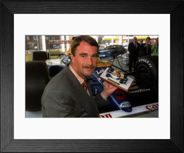 Framed Print : Nigel Mansell Formula One racing driver with a model of himself Framed Print : Nigel Mansell Formula One racing driver with a model of himself