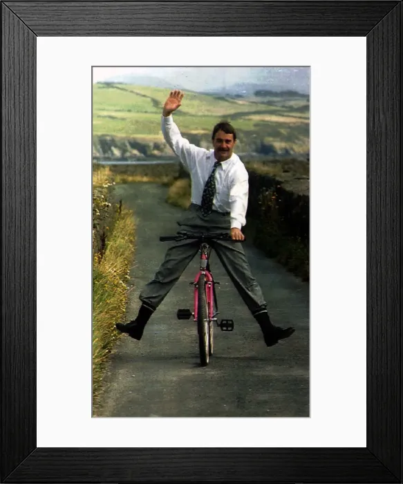 Framed Print : Nigel Mansell Formula One Racing Driver Riding A Bicycle Down A Country Lane Framed Print : Nigel Mansell Formula One Racing Driver Riding A Bicycle Down A Country Lane
