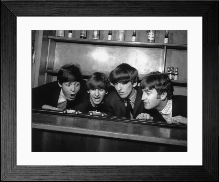 Framed Print : The Beatles in Coventry, amusing themselves with a miniture car race track before their Framed Print : The Beatles in Coventry, amusing themselves with a miniture car race track before their