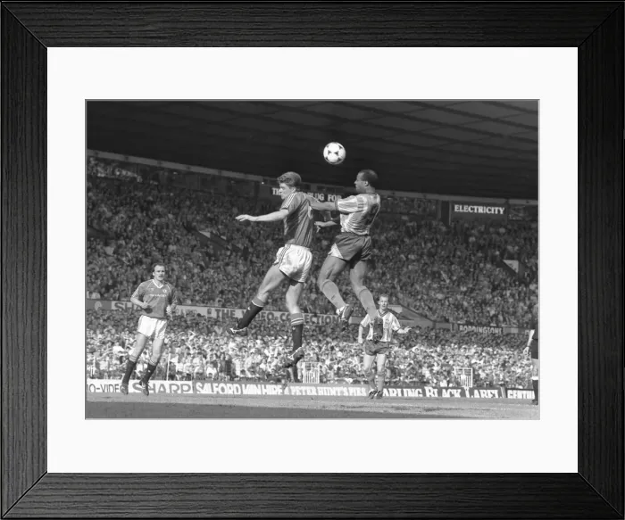 Framed Print : Manchester United v Coventry City. Cyrille Regis wins the header against Manchester Framed Print : Manchester United v Coventry City. Cyrille Regis wins the header against Manchester