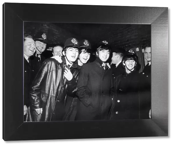 The Beatles wearing Policemens helmets in Birmingham after concert at the Hippodrome