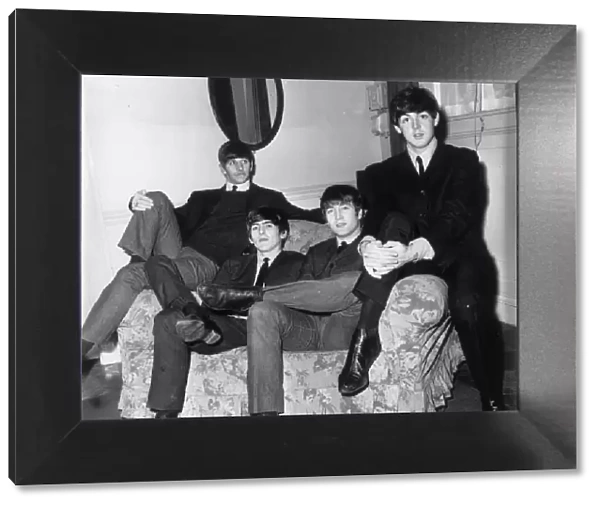 The Beatles sitting on a sofa during their visit to Newcastle