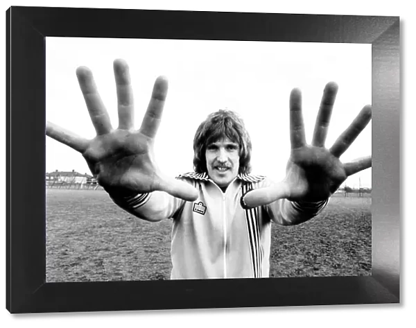 West Ham goalkeeper Phil Parkes shows his large hands to the camera