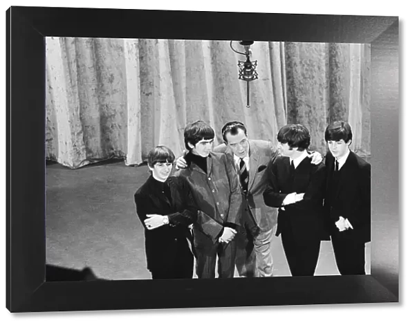 British pop group The Beatles with American talk show host Ed Sullivan on the set of his