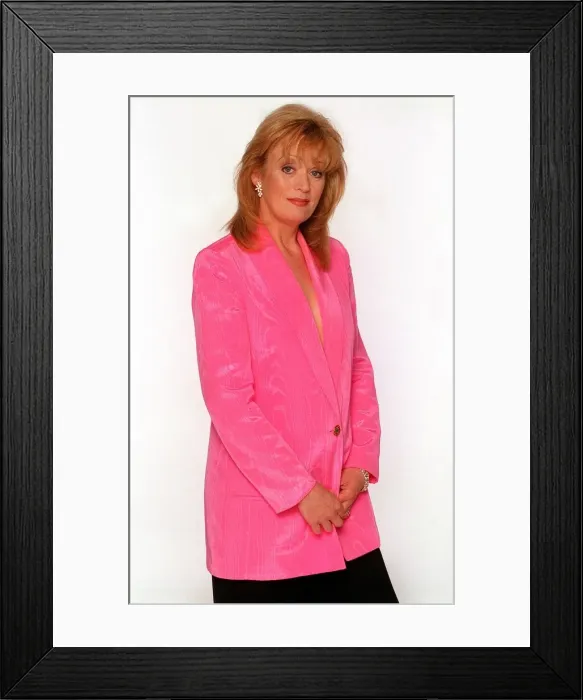 Framed Print : Coronation Street actress Sherrie Hewson poses in the studio wearing a pink silk blazer Framed Print : Coronation Street actress Sherrie Hewson poses in the studio wearing a pink silk blazer