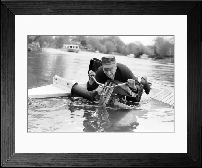 Framed Print : Pensioner Patrick Thomas pictured on his lying down bicycle equipped with floats as he Framed Print : Pensioner Patrick Thomas pictured on his lying down bicycle equipped with floats as he