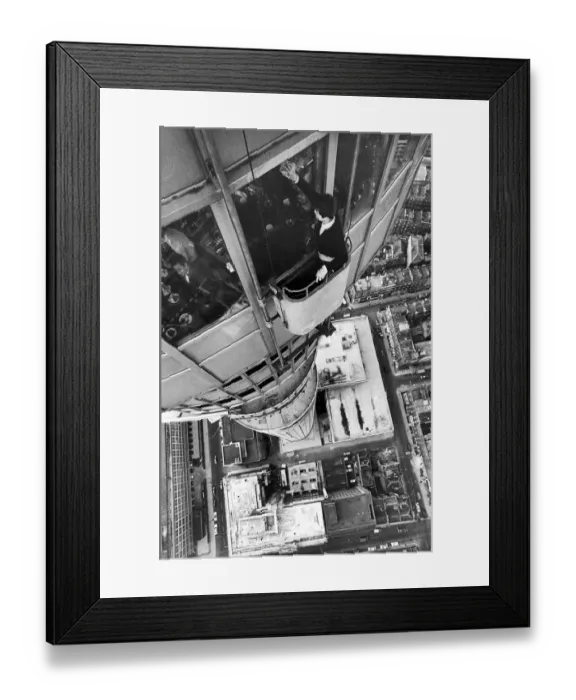 Framed Print : Window cleaner Adrian Rogers in his cradle as he cleans one of the many windows Framed Print : Window cleaner Adrian Rogers in his cradle as he cleans one of the many windows