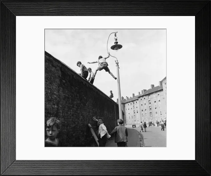 Framed Print : Children climb lamposts and scale high walls to get a better view of the England v