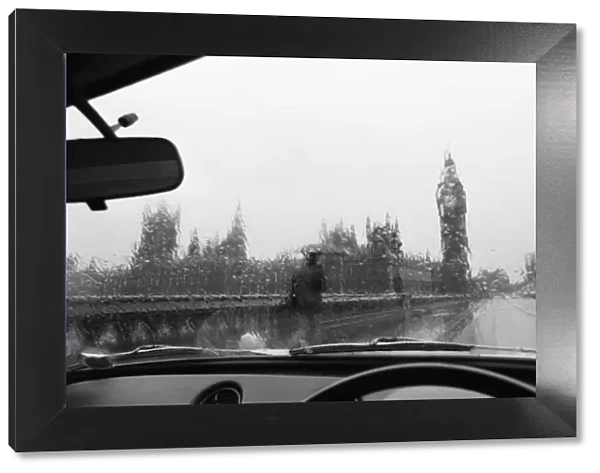 General view of the Houses of Parliament and Big Ben taken through the rain washed window