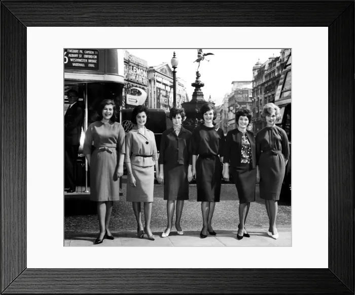 Framed Print : Six girls wearing the latest Marks and Spencer clothes pose at Piccadilly Circus in
