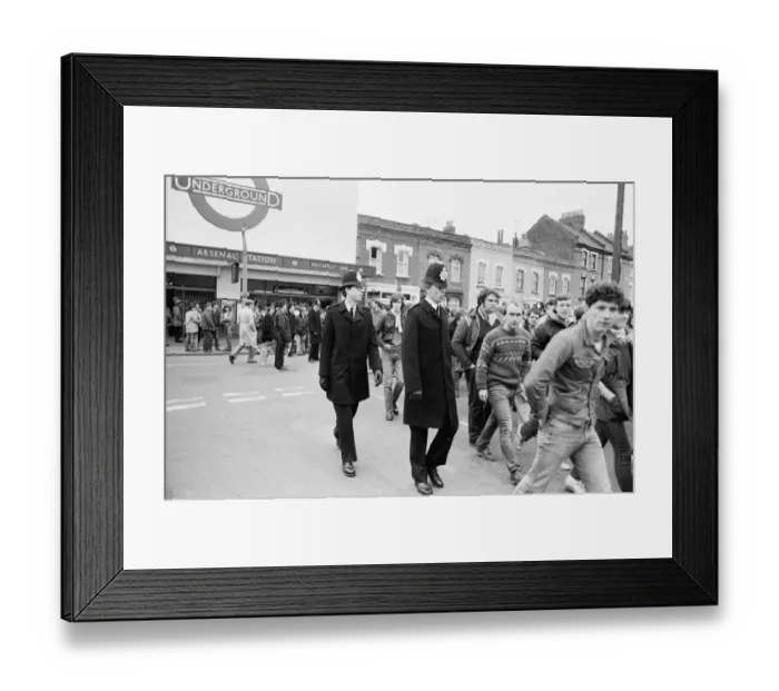 Framed Print : Police keep an eye on Leeds United supporters at the Arsenal football ground as fans Framed Print : Police keep an eye on Leeds United supporters at the Arsenal football ground as fans