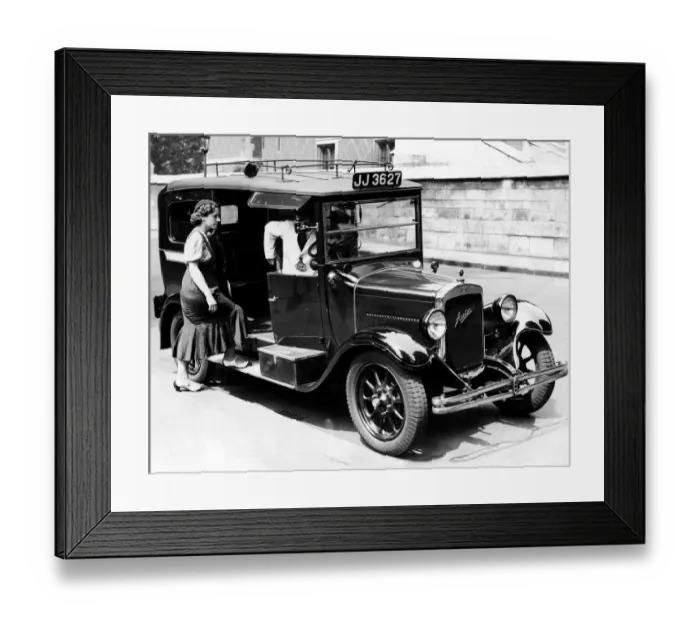 Framed Print : A female passenger entering one of the new London taxi cabs that can travel up to 50 Framed Print : A female passenger entering one of the new London taxi cabs that can travel up to 50