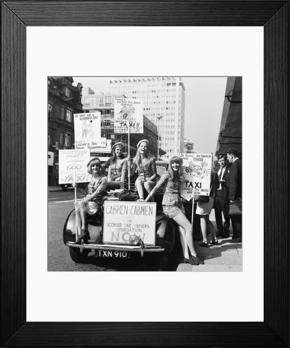 Framed Print : Four girls wearing mini skirts pose on the front of a taxi cab as part of a campaign Framed Print : Four girls wearing mini skirts pose on the front of a taxi cab as part of a campaign
