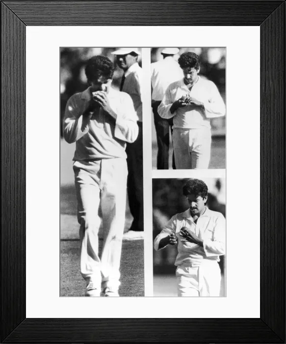 Framed Print : A bowler appears to be picking the seam of a ball before a delivery. 1992