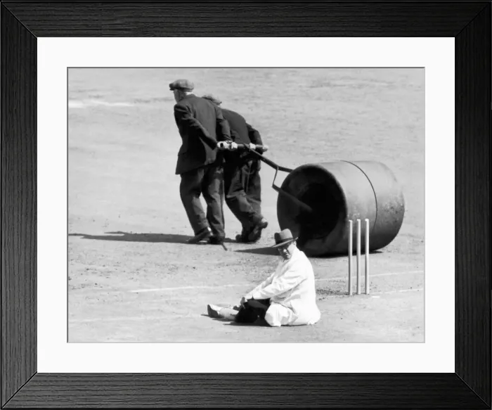 Framed Print : Umpire taking a rest whilst groundsmen roll the wicket. 15th July 1952 Framed Print : Umpire taking a rest whilst groundsmen roll the wicket. 15th July 1952