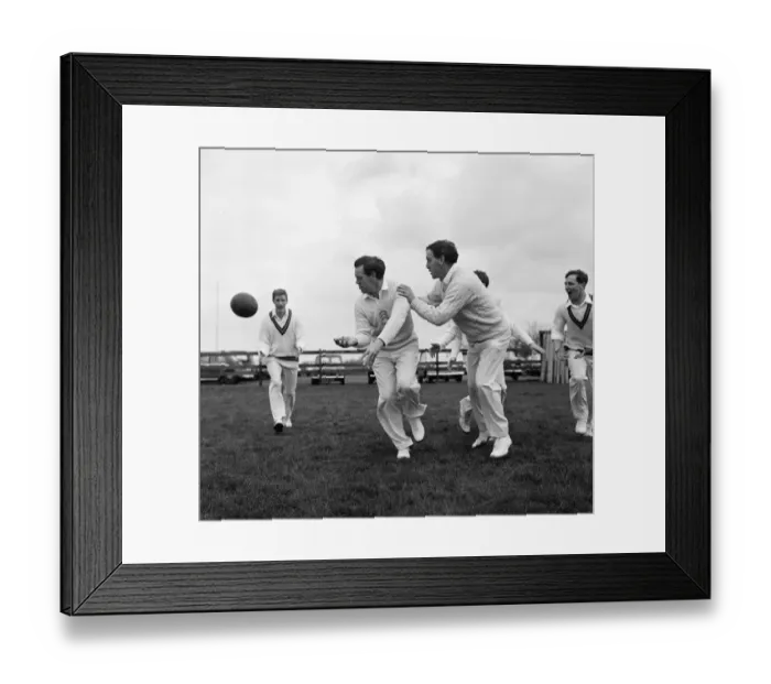 Framed Print : Limbering up with a rugby ball are Essex cricket team members Ken Preston (centre
