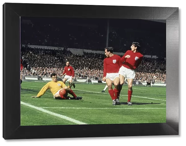 Gordon Banks dives to save the ball. Also in the penalty area watching from left to right