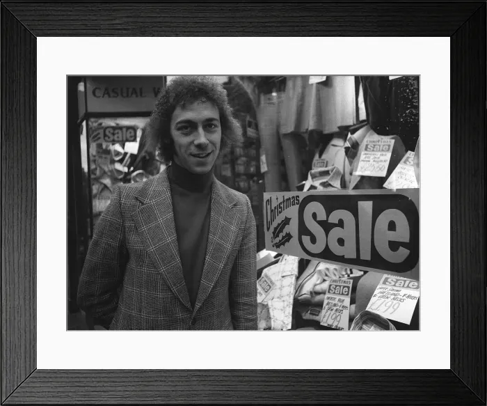 Framed Print : Charlie George football player of Arsenal December 1974 outside a men clothing