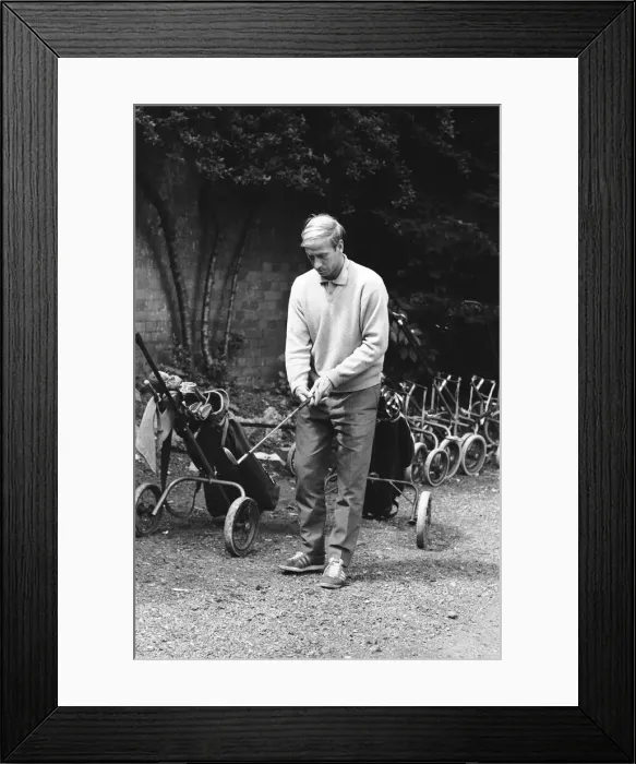 Framed Print : England footballer Bobby Charlton chosses his club as enjoys a round of golf during an Framed Print : England footballer Bobby Charlton chosses his club as enjoys a round of golf during an