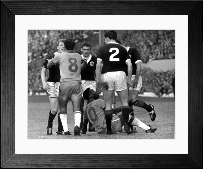 Framed Print : Brazilian football star Pele on a heap on the ground after clashing with Scotland Framed Print : Brazilian football star Pele on a heap on the ground after clashing with Scotland