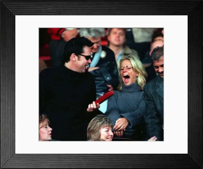 Framed Print : Vic Reeves and Ulrika Jonsson TV Presenter sitting in the stands at Old Trafford to watch