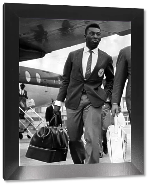 Brazil and Santos football star Pele walks along the tarmac after arriving at Ringway