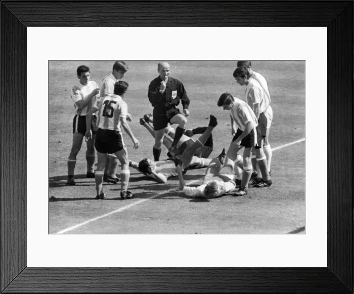 Framed Print : Jack Charlton (R) on ground about to be kicked by an Argentinian Player Framed Print : Jack Charlton (R) on ground about to be kicked by an Argentinian Player