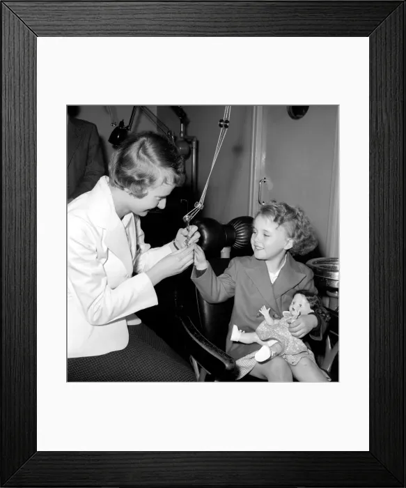 Framed Print : Girl in the Dentists Chair at a Dental Clinic for children. 1954
