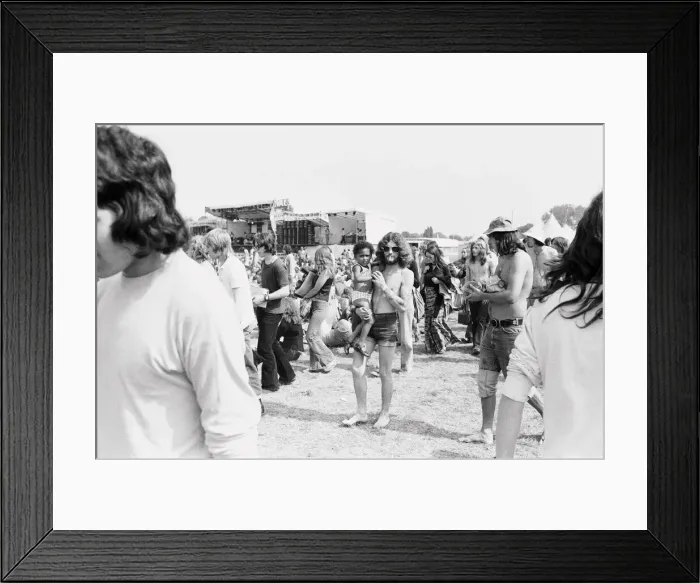 Framed Print : Reading Pop Festival. Festival goers walking around near the main stage