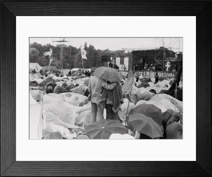 Framed Print : Reading Pop Festival. Young couple stand up to get a better view of the main stage Framed Print : Reading Pop Festival. Young couple stand up to get a better view of the main stage