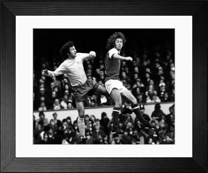 Framed Print : Charlie George Football Player March 1973 jumps with Roy McFarland for the ball Framed Print : Charlie George Football Player March 1973 jumps with Roy McFarland for the ball