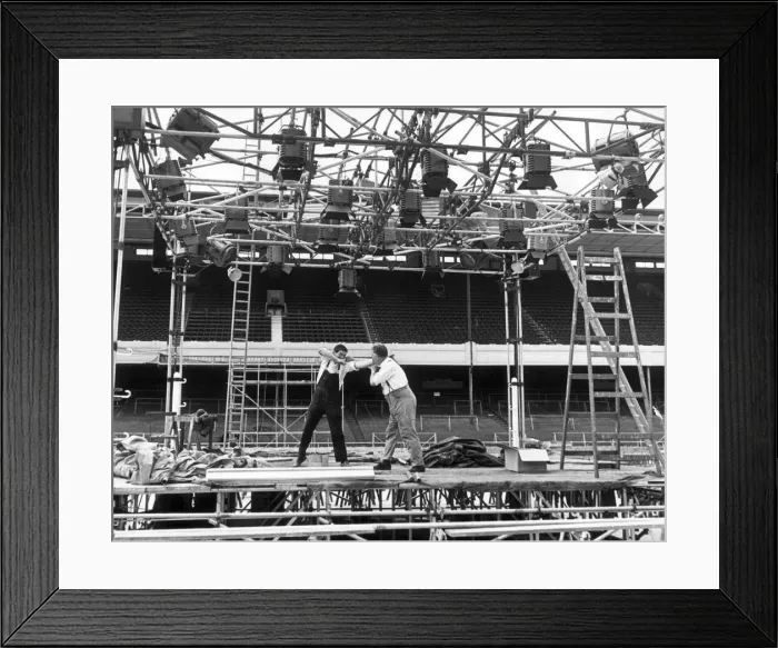 Framed Print : Scaffolders at Highbury having a quick round during their lunch break Framed Print : Scaffolders at Highbury having a quick round during their lunch break