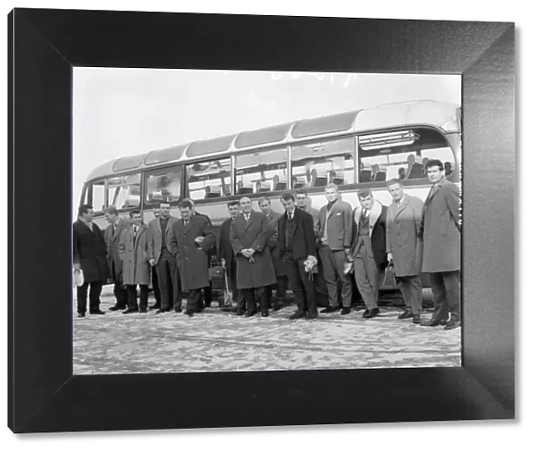 New England manager Alf Ramsey stands in front of the team bus with his squad of players