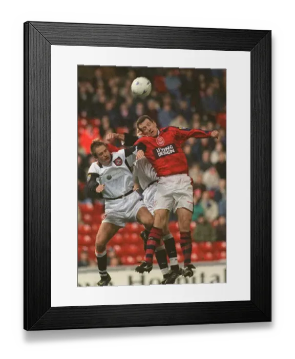  : Brian Irvine Aberdeen football player challenges Dundee United players for the ball