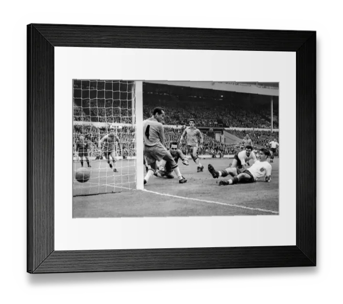 Framed Print : Brian Douglas England football player scores goal past Zequinha (No