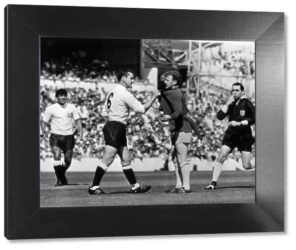 Dave Mackay of Tottenham Hotspur confronts Billy Bremner of Leeds during their First