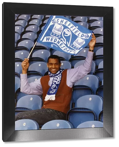 Mark Bright footballer for Sheffield Wednesday sits in seats and waves a flag