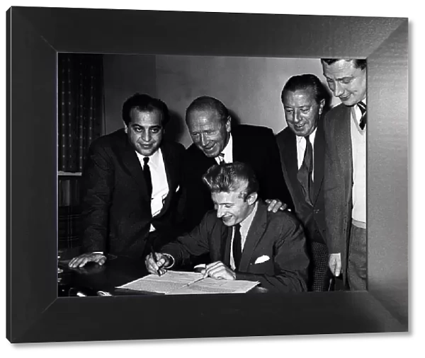 Denis Law signs for Manchester United witnessed by Manchester United Manager Matt Busby