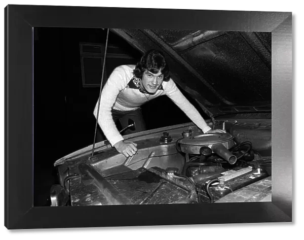 Footballer Glenn Hoddle at home with his car 1976