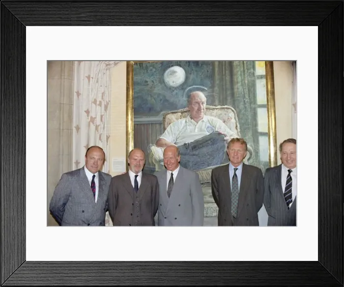 Framed Print : Manchester United director Bobby Charlton (centre) standing in front of a painting of him