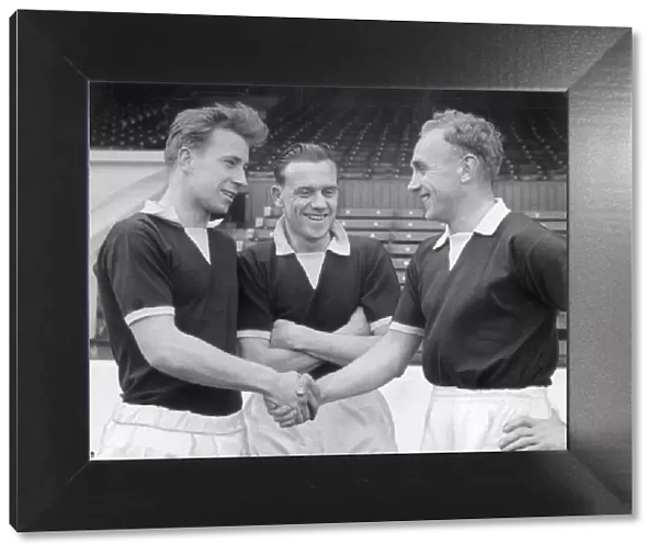 England captain Billy Wright (right) shakes hands with new recruit Bobby Charlton of