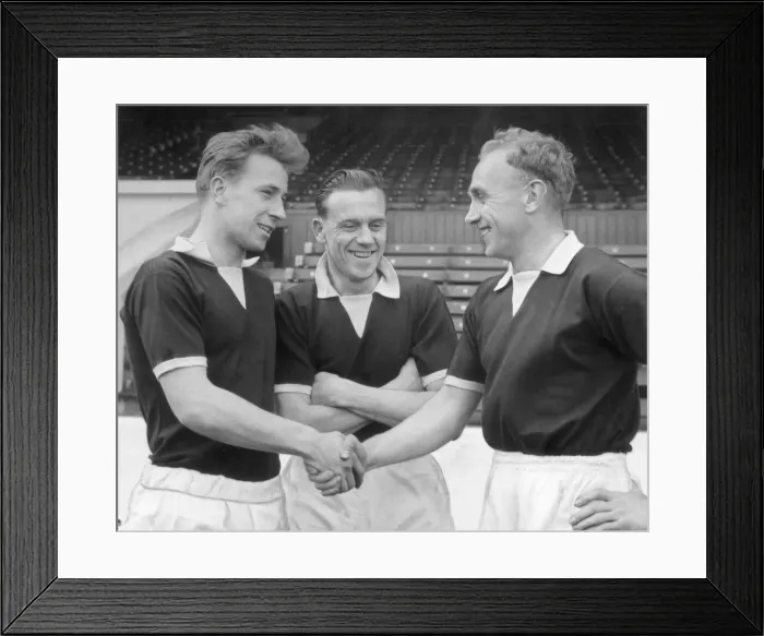 Framed Print : England captain Billy Wright (right) shakes hands with new recruit Bobby Charlton of Framed Print : England captain Billy Wright (right) shakes hands with new recruit Bobby Charlton of