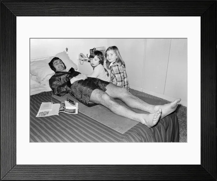 Framed Print : Larry Lloyd Coventry City football player lying on bed at home as he recuperates Framed Print : Larry Lloyd Coventry City football player lying on bed at home as he recuperates
