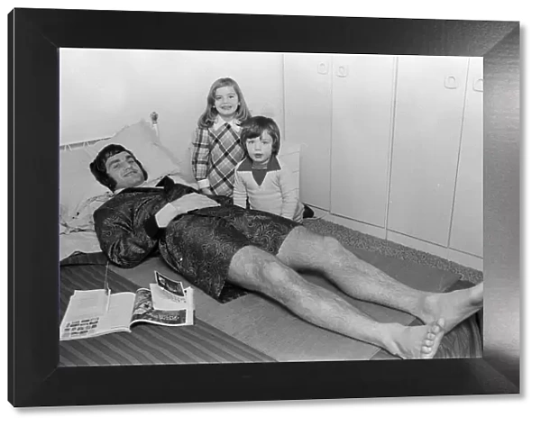 Larry Lloyd Coventry City football player lying on bed at home as he recuperates