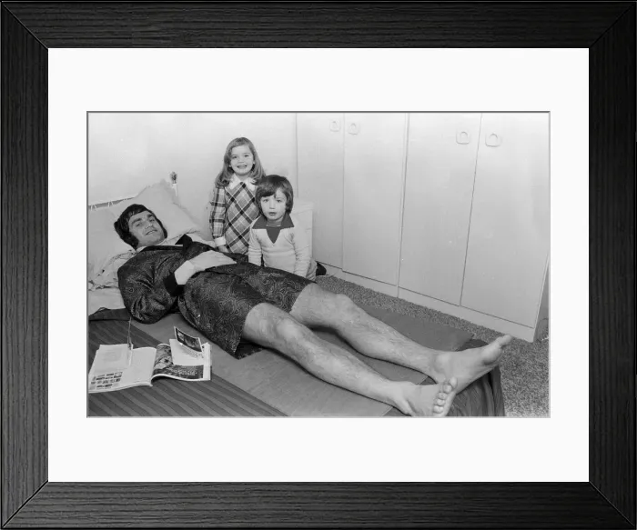 Framed Print : Larry Lloyd Coventry City football player lying on bed at home as he recuperates