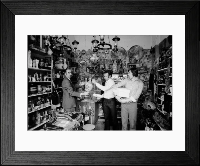 Framed Print : Leeds United players buying gifts in a local shop as they take a walk around the town of Framed Print : Leeds United players buying gifts in a local shop as they take a walk around the town of