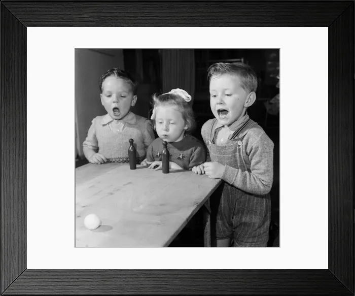 Framed Print : Four year old children of Bridgeton Day Nursery in Glasgow playing a game of blow
