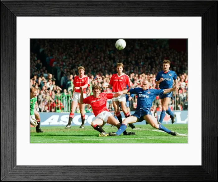 Framed Print : Steve Bruce tries to keep out Andy Ritchie. FA Cup. Manchester United 3 v Oldham Athletic Framed Print : Steve Bruce tries to keep out Andy Ritchie. FA Cup. Manchester United 3 v Oldham Athletic